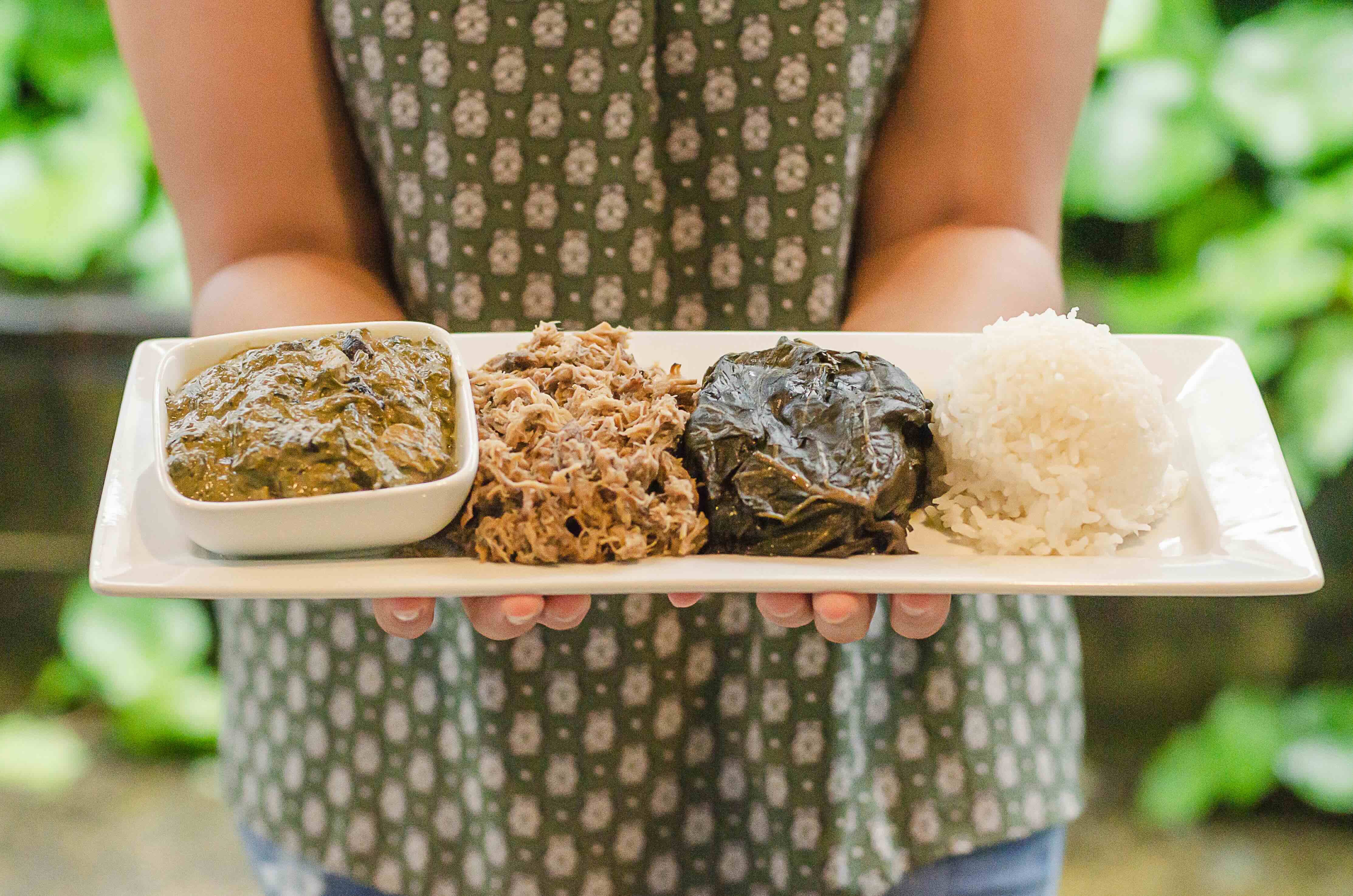 Hawaiian plate held with squid luau kalua pig lau lau and rice